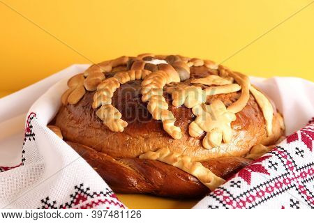 Rushnyk With Korovai On Yellow Background, Closeup. Ukrainian Bread And Salt Welcoming Tradition