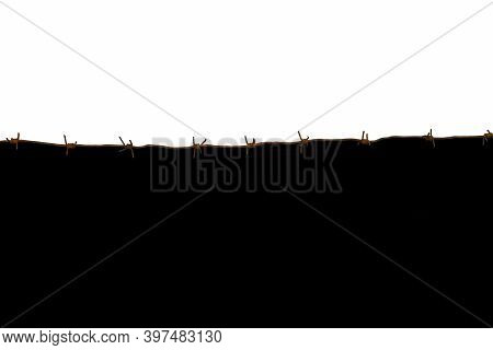 Barbed Wire Separating White And Black Backgrounds. The Concept Of The Border Between Good And Evil.