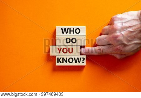 Who Do You Know Symbol. Wooden Blocks With Words 'who Do You Know'. Male Hand. Beautiful Orange Back