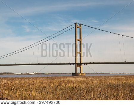 A Tower And Section Of The Humber Bridge Seen Across A Reed Bed In North Lincolnshire, England