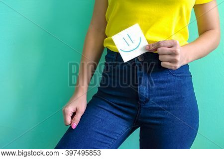 Girl Holds A Little Piece Of Paper Note With Happy Emoji On It. Concept Of Healthy Stomach And No Me