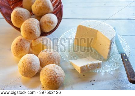 Cheese Bread From Brazil, Paes De Queijo And Minas Cheese On An Old White Table With Blurred Nature