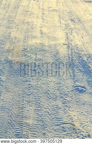 Tire Tracks Left In The Snow On A Bright Sunny Day. The Concept Of Snow Removal, Ski Resorts, Active