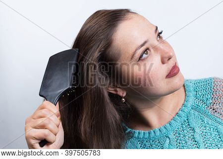 Young Girl Combing. Combing And Dreaming