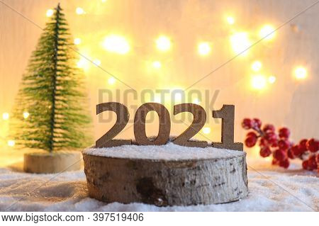 Beautiful New Year Greeting Card With Selective Focus. Numbers 2021 On Wooden Stand Against Festive 