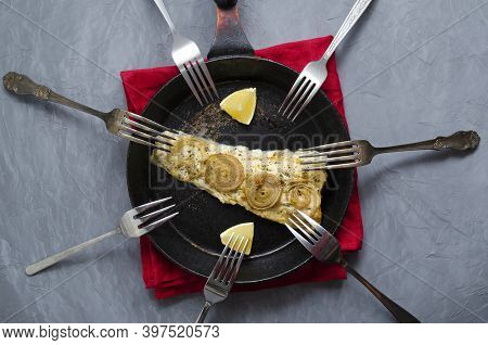 Fried Baked Mackerel Trachurus With Onions And Dried Herbs In An Old Frying Pan In A Towel, Many Dif