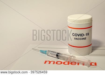 Moderna Coronavirus Vaccine With A Syringe And The Company Logo On A White Background, Denmark, Dece
