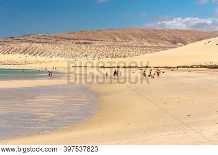 Sotavento, Fuerteventura, Spain: 2020 October 8: Young Blonde Woman Walks Through The Dunes At Playa