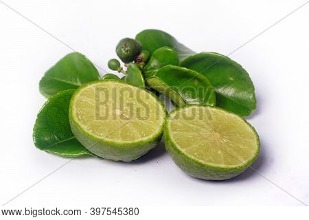 Kaffir Lime Or Citrus Hystrix. Some Are Whole, Some Have Been Sliced. Focus Selected, White Backgrou