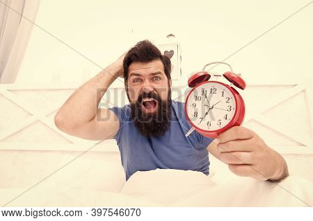 Get Up Right Now. What Time Is It. Stressed Man Alarm Clock. Sleepy Man Holding Alarm Clock In Bed. 
