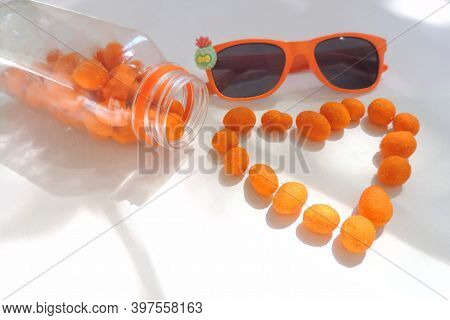 Heart Shaped Peanuts In Orange Glaze , Sunlight And Shadow, Selective Focus