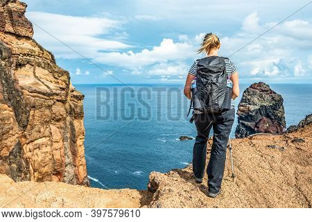 Girl Hiking Rocky Cliffs Clear Near Water Of Atlantic Ocean Bay Ponta De Sao Lourenco, The Island Of
