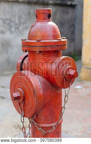 Red Fire Hydrant Water Pipe Near The Road. Fire Hydrant For Emergency Fire Access