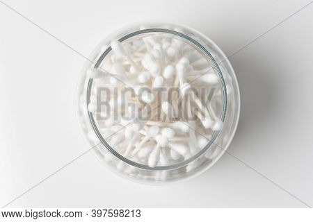 High angle view of a glass jar full of Cotton Swabs. 