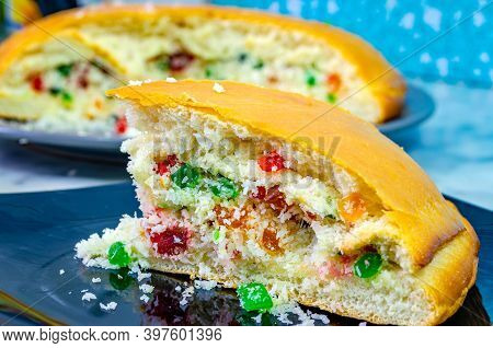 Closeup Of Tutti Frutti And Desiccated Coconut Stuffed Dilkush Piece In A Black Plate.