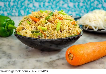 Closeup Of Idiyappam Noodles (indian Rice Noodles) In A Black Bowl With Carrot And Capsicum On The S