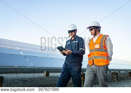 Engineers With Investor Walk To Check The Operation Of The Solar Farm(solar Panel) Systems, Alternat