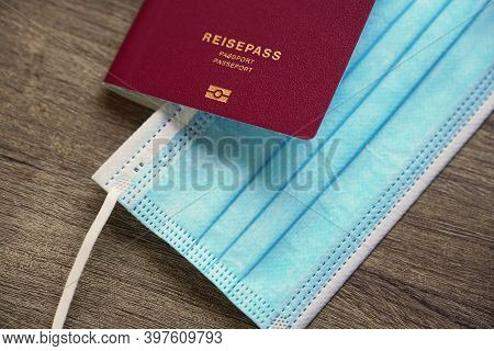 German Passport Reisepass And Medical Face Mask - Travel During Corona Covid Pandemic Concept - Sele