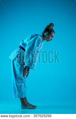 View From Side. Professional Female Judoist In White Judo Kimono Practicing And Training Isolated On