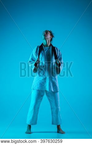 Take A Rest. Professional Female Judoist In White Judo Kimono Practicing And Training Isolated On Bl