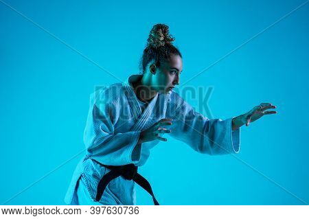 View From Side. Professional Female Judoist In White Judo Kimono Practicing And Training Isolated On