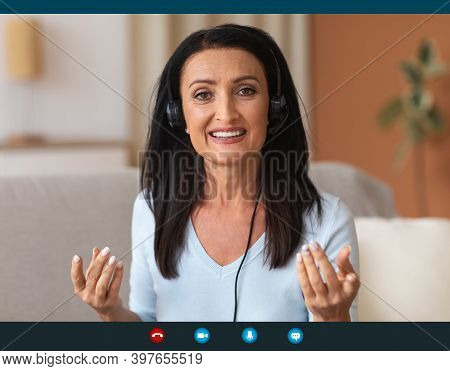 Remote Work And Technology. Mature Woman Wearing Headset Having Video Conference, Talking To Camera 