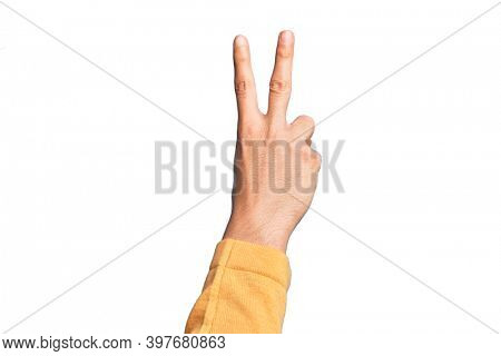 Hand of caucasian young man showing fingers over isolated white background counting number 2 showing two fingers, gesturing victory and winner symbol