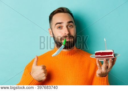 Close-up Of Funny Adult Man Celebrating His Birthday, Holding Bday Cake With Candle, Blowing Party W