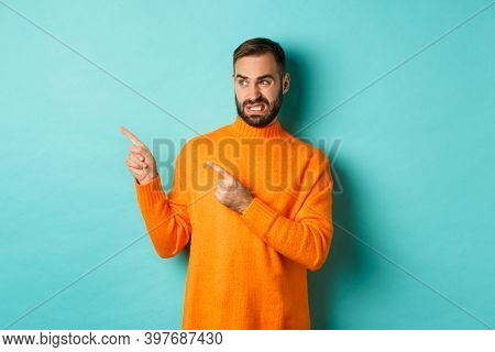 Displeased Man Cringe From Something Bad, Pointing And Looking At Something Disgusting Or Strange, L