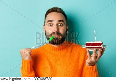 Close-up Of Funny Adult Man Celebrating His Birthday, Holding Bday Cake With Candle, Blowing Party W