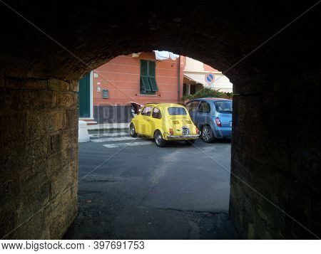 Five Lands, Italy - Summer 2020: An Iconic Yellow Fiat Cinquecento Parked In An Italian Street. High
