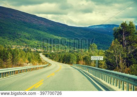 Mountain Road At Sunset With Cloudy Sky