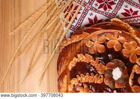 Rushnyk With Korovai, Wheat Spikes On Wooden Table, Flat Lay. Ukrainian Bread And Salt Welcoming Tra