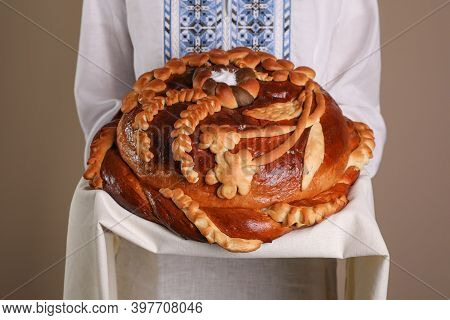 Woman With Korovai On Grey Background, Closeup. Ukrainian Bread And Salt Welcoming Tradition