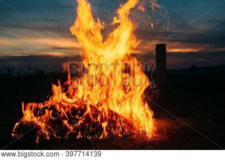 Big Bonfire On The Background Of Sunset.