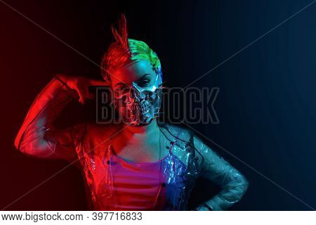 Crazy Suicidal Cyberpunk Woman With Mohawk Hairstyle In Spiked Skull Mask With Finger On Her Forehea