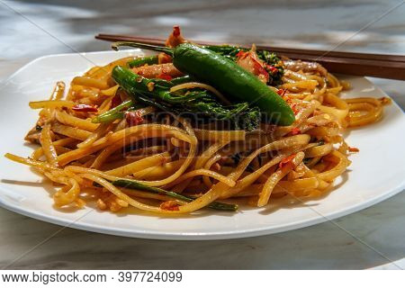 Pad Kee Mao Otherwise Known As Drunken Noodles Is A Spicy Thai Stir-fried Noodle Dish With Thinly Sl