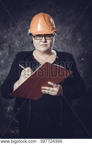 Middle-aged Woman Construction Superintendent In Helmet Studio Portrait.