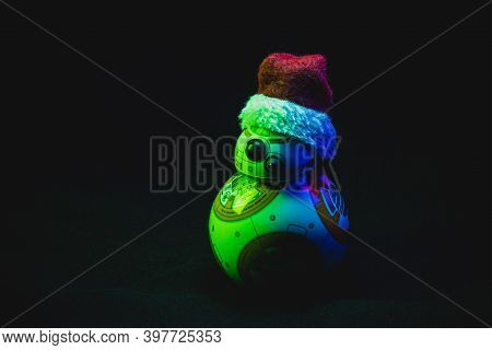 Caba, Argentina, November 28, 2020: Lovely Droid Bb-8 From Star Wars, Wearing A Christmas Hat In Dar
