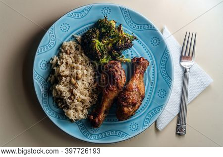 Authentic Spicy Jamaican Jerk Chicken Legs Served With Coconut Rice And Pigeon Peas