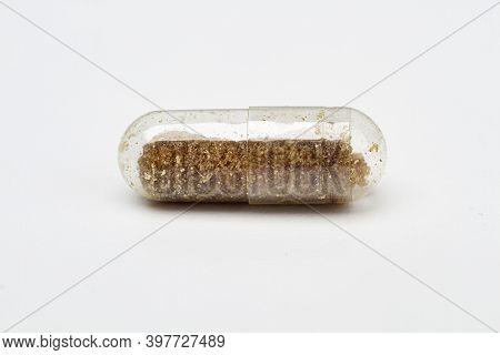 Transparent Pill, Only Partialy Filled With Brown Ingredient