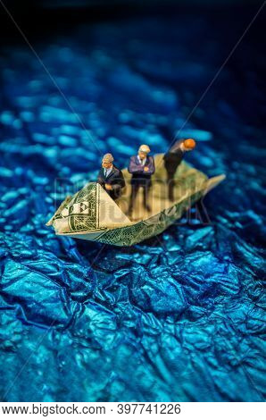 Miniature Figurine Businessmen Ride On Dollar Bill Origami Yacht