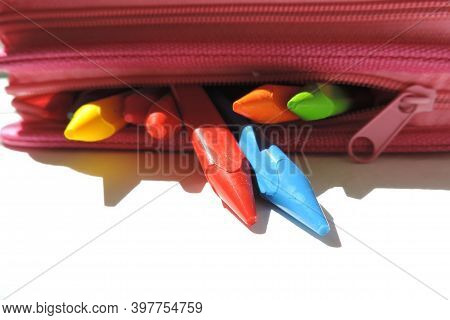 Colored Wax Crayons Stick Out From A Pink Pencil Case