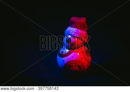 Caba, Argentina, November 28, 2020: Lovely Droid Bb-8 From Star Wars, Wearing A Christmas Hat In Dar