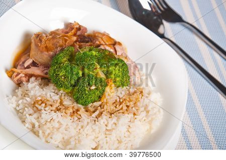 carne di tacchino, condita con sugo su un lato e broccoli al vapore