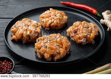 Raw Fish Patties With Salmon And Lemongrass, On Black Wooden Table