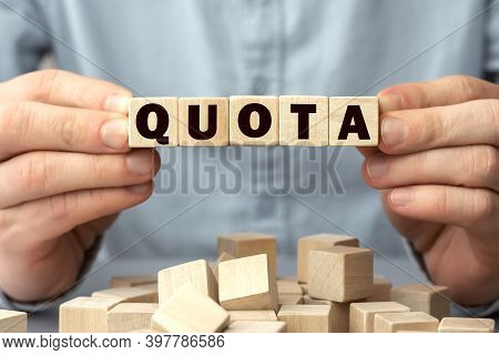 The Word Quota Made From Wooden Cubes. Conceptual Photo. Selective Focus. Shallow Depth Of Field On 