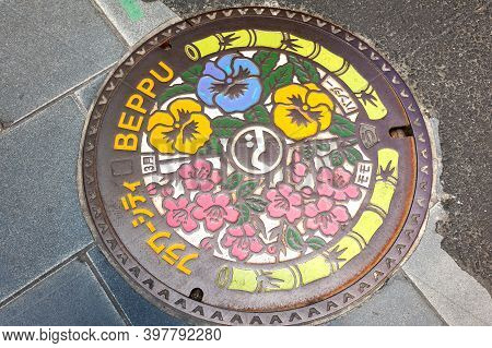 Beppu, Kyushu, Japan, July 16, 2017: Beautiful Drain Manhole Cover With A Picture Of Flowers. Manhol