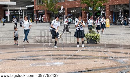 Oita, Kyushu, Japan August 04,2017: Young Japanese Schoolgirls Have Fun On The Way From School On Th
