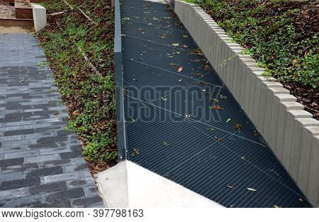 Gray Monolithic Concrete Park Bench Made Of Concrete In The Shape Of Round Stones Wooden Staircase B